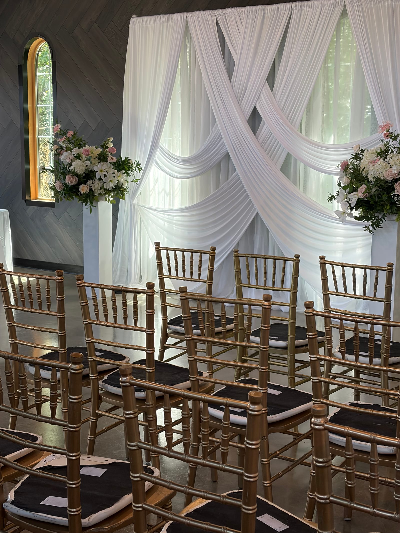 Draped hall with gold chairs set for a wedding at The Prairie Shanty at Four Sisters Farm