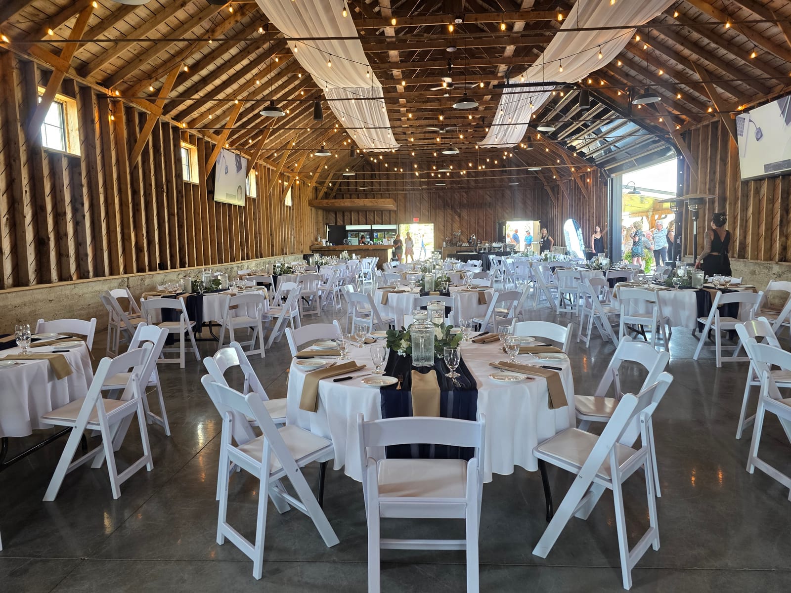 Barn reception with draping and string lights at The Byre near Lethbridge