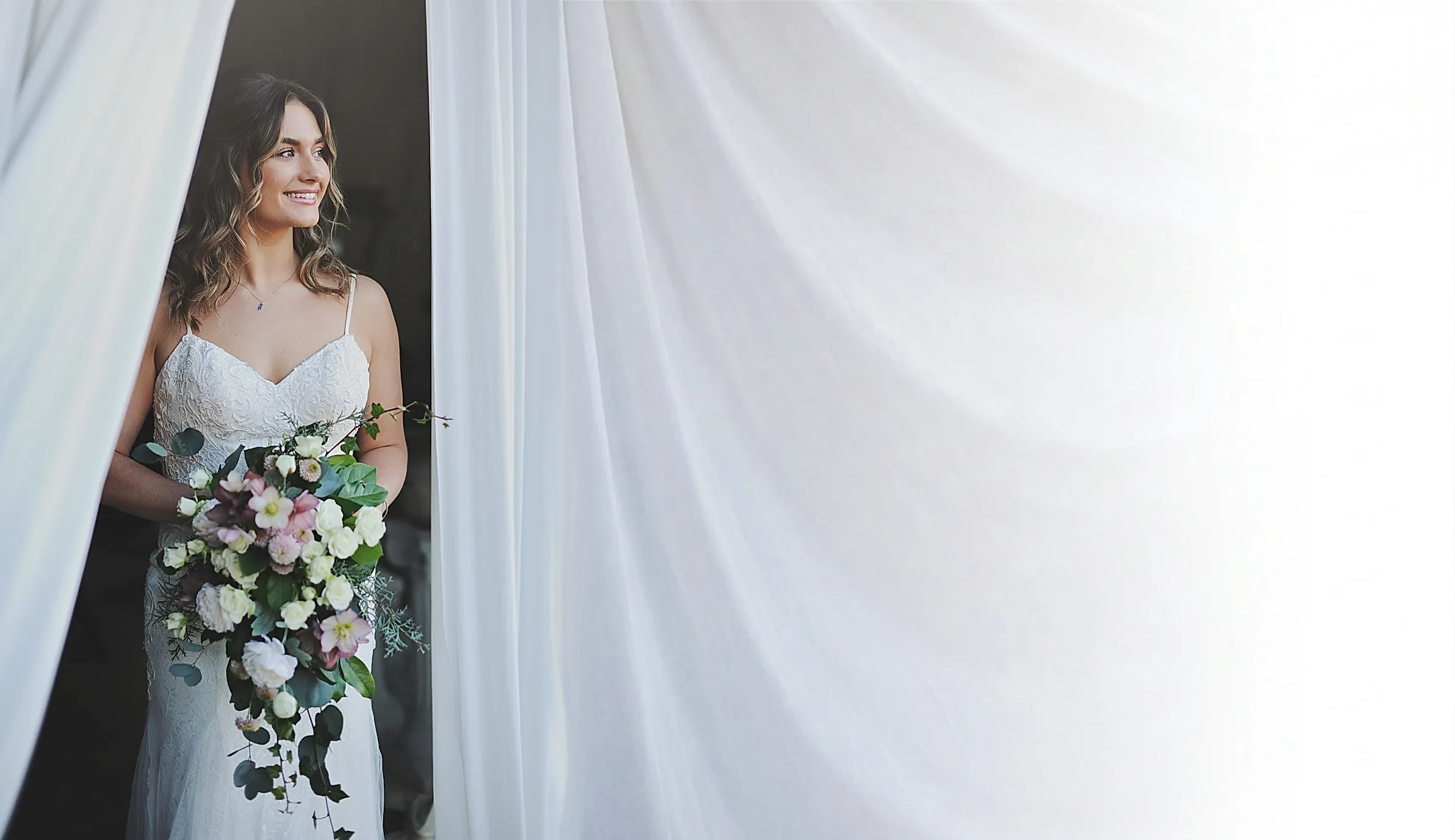 Smiling bride holding her bouquet at The Truffle Farm