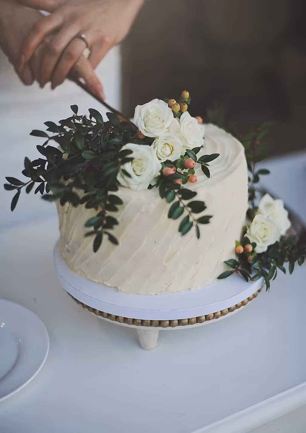 Two-tier wedding cake decorated with fresh flowers