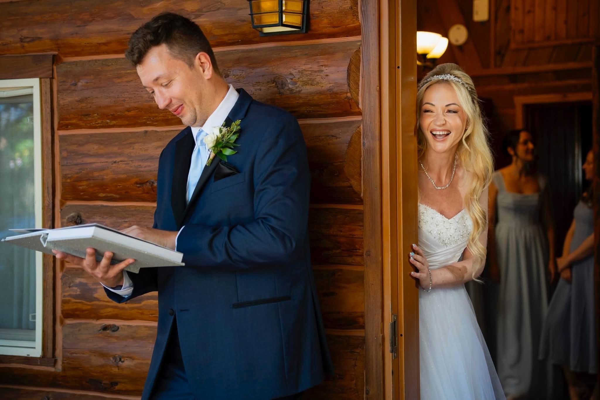 The groom reading a letter outside the cabin while Charlene peeks around the door