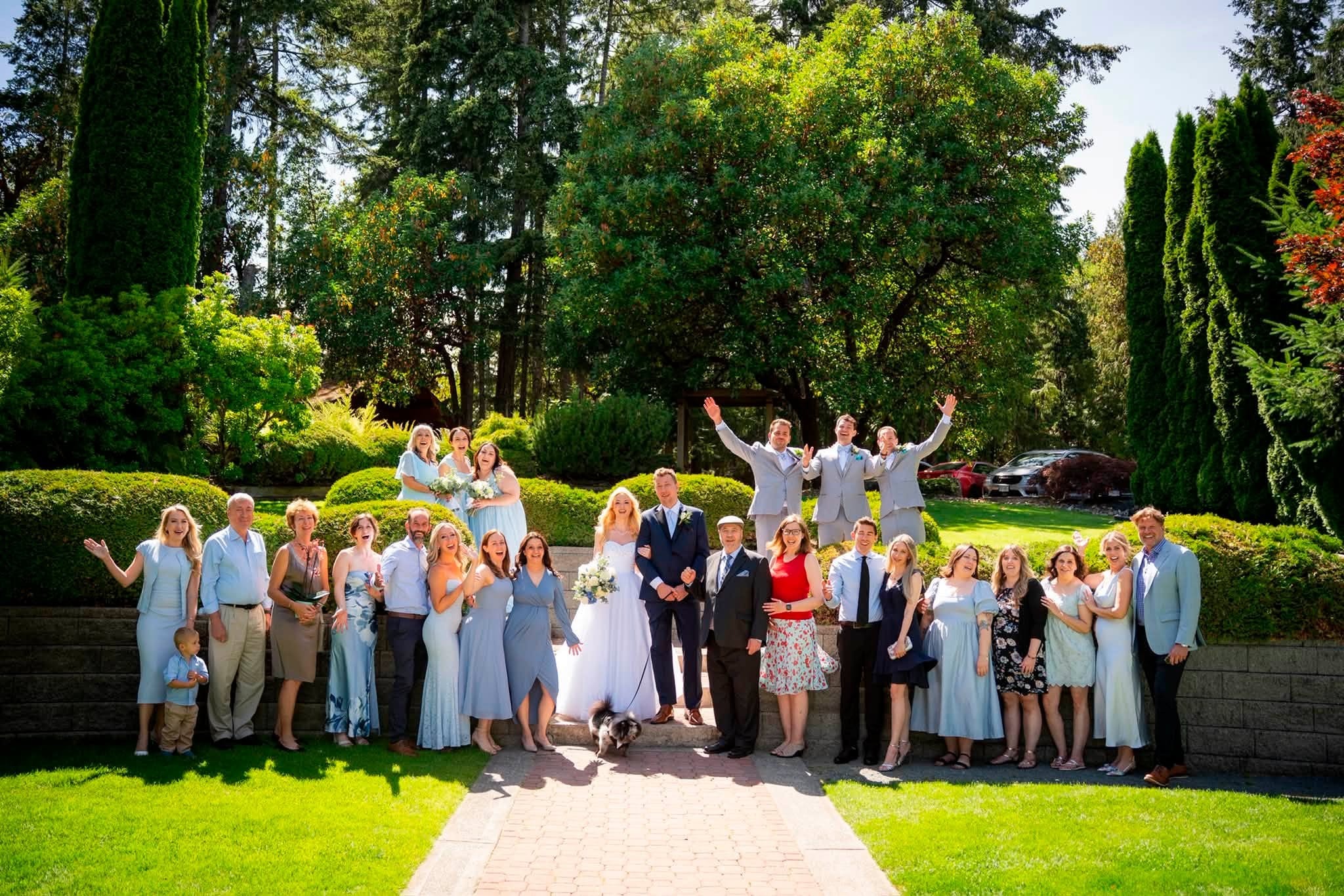 All the guests in the gardens with the couple's dog