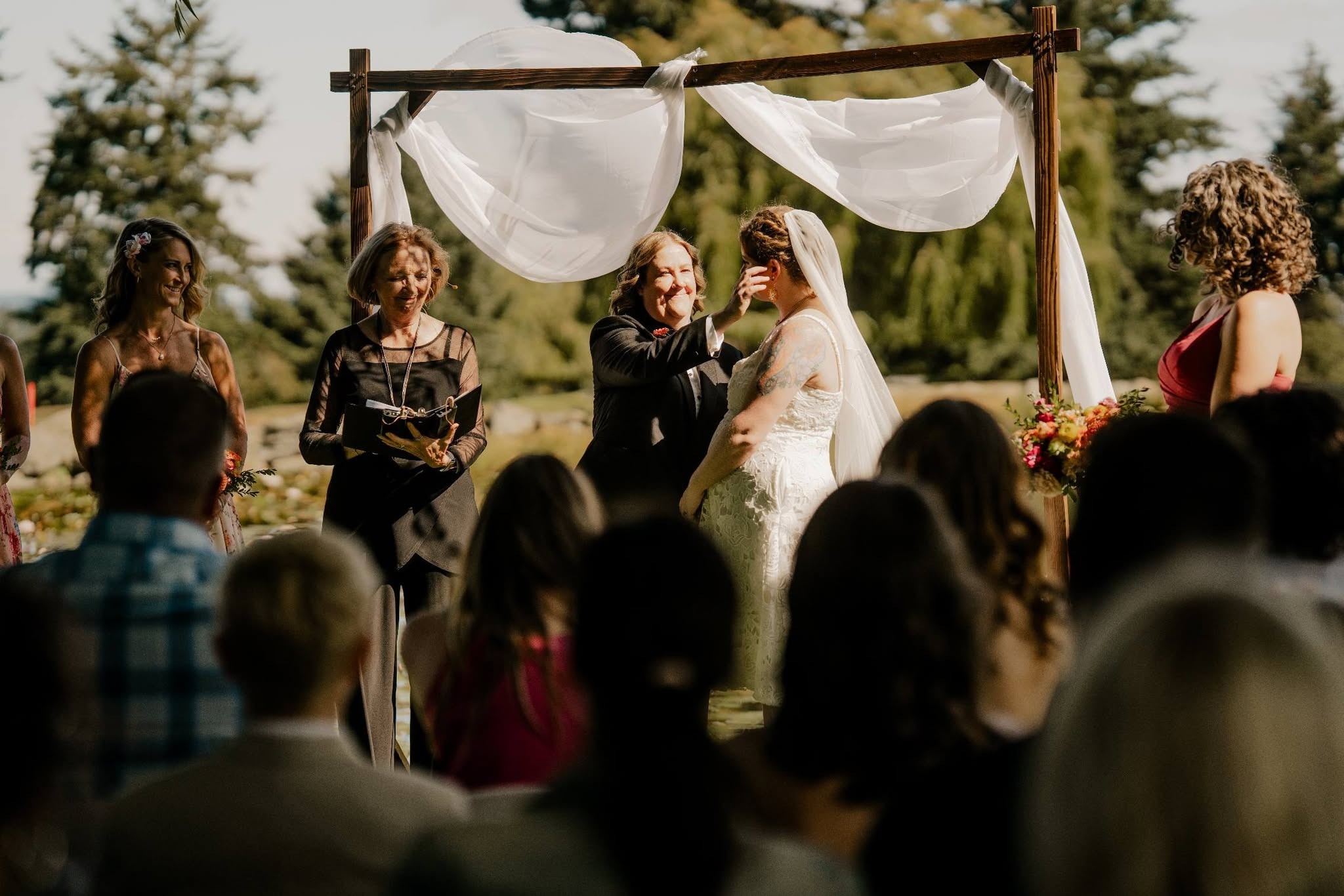 Deavon's wife wiping a happy tear from Deavon's cheek at the arbour