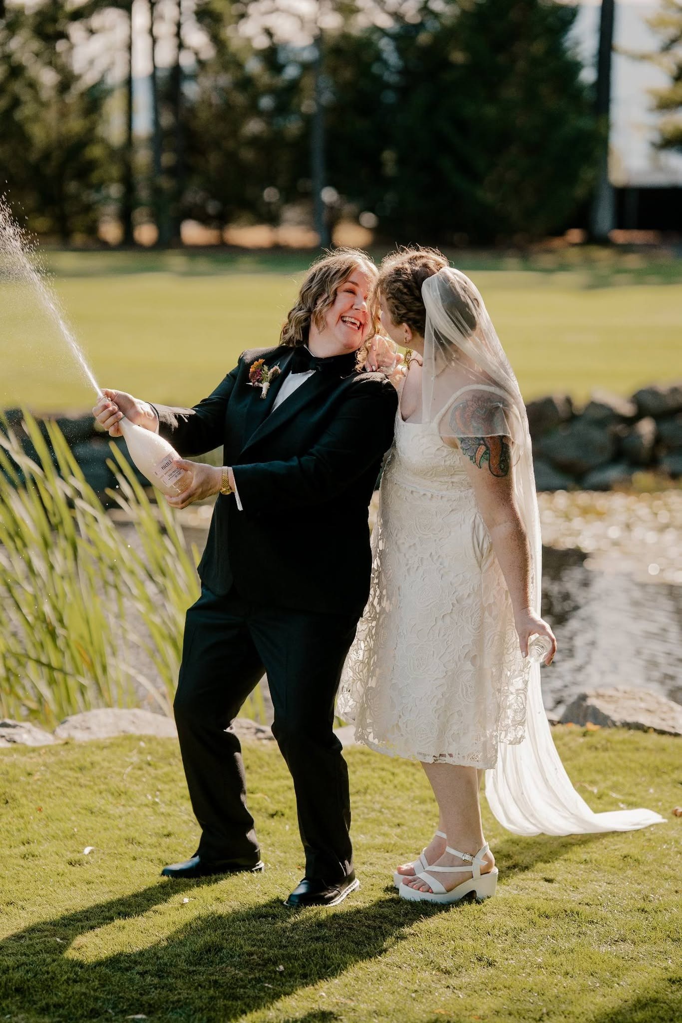 Deavon's wife popping champagne on the green, both of them laughing