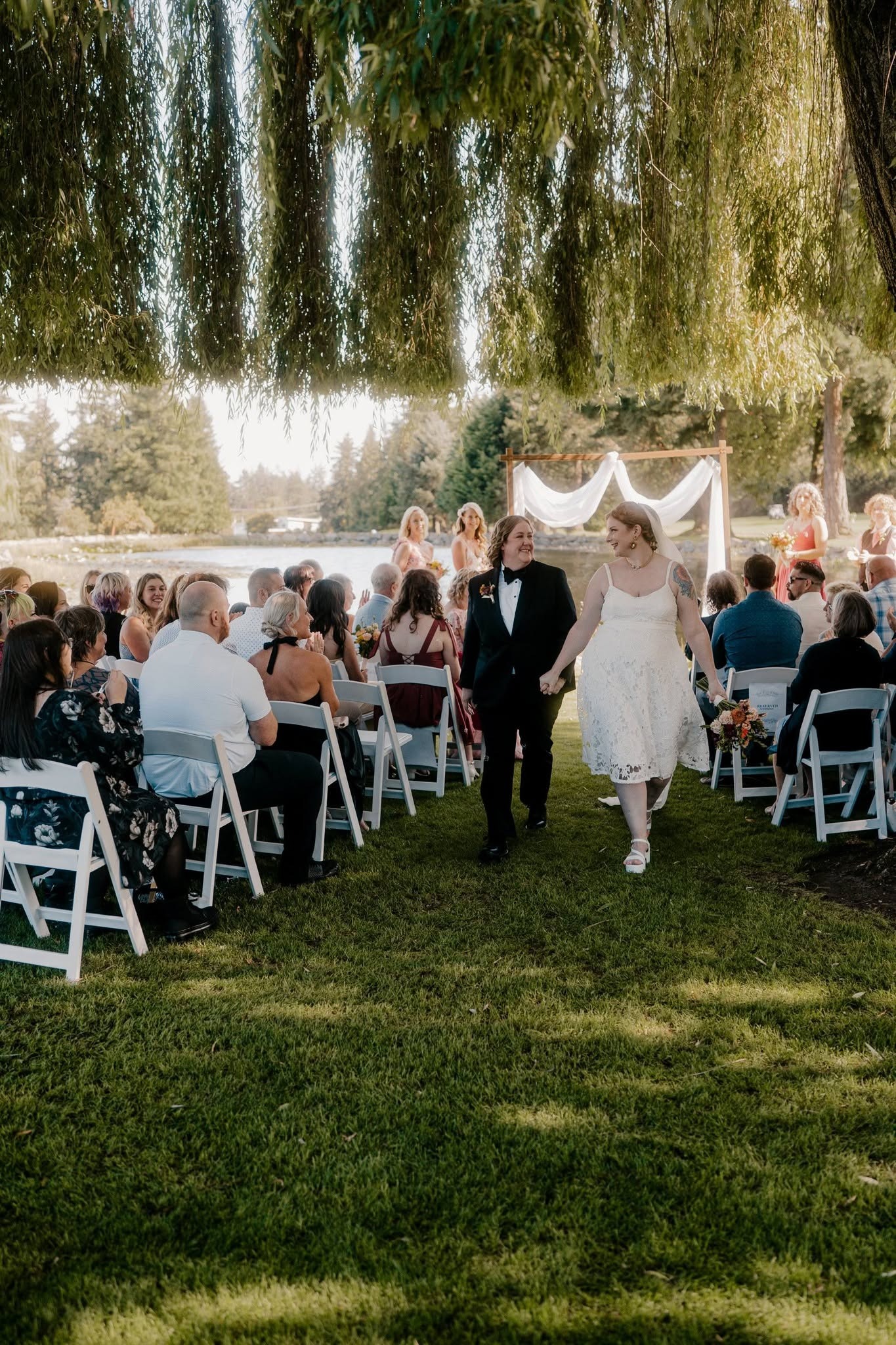 The newlyweds walking back up the aisle hand in hand