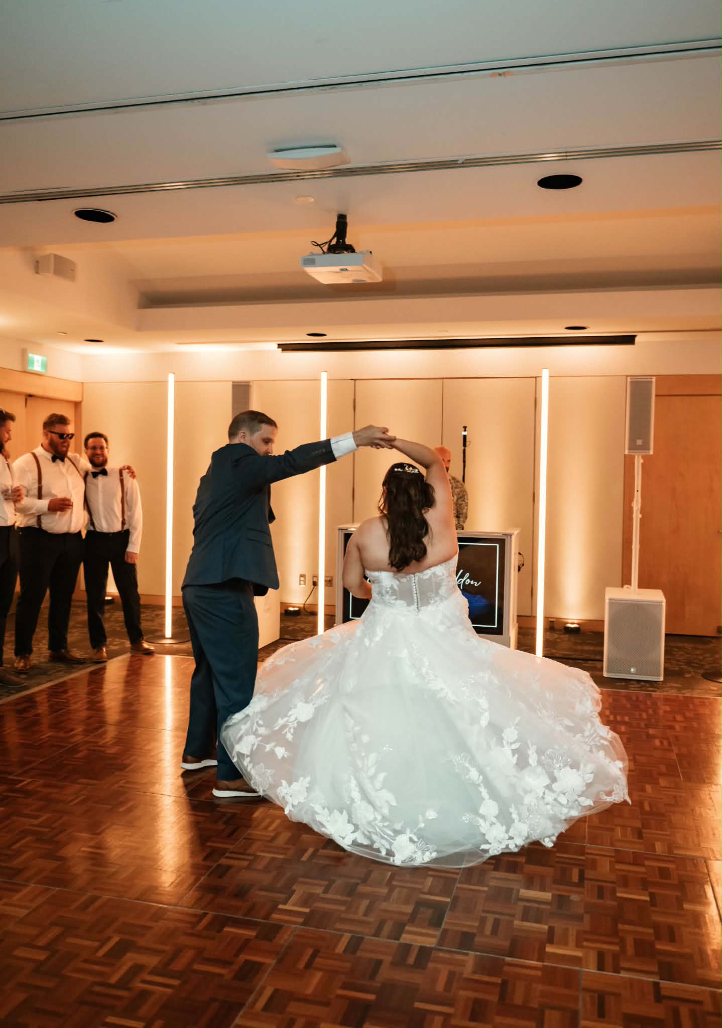 Sheldon twirling Emily on the dance floor